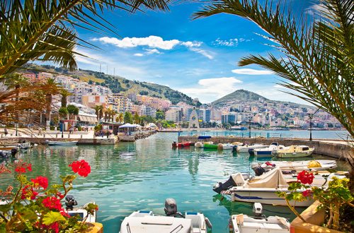 Scenic waterfront with boats and flowers