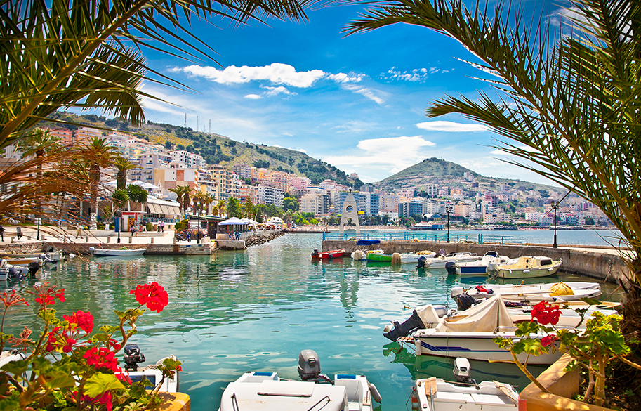 Scenic waterfront with boats and flowers