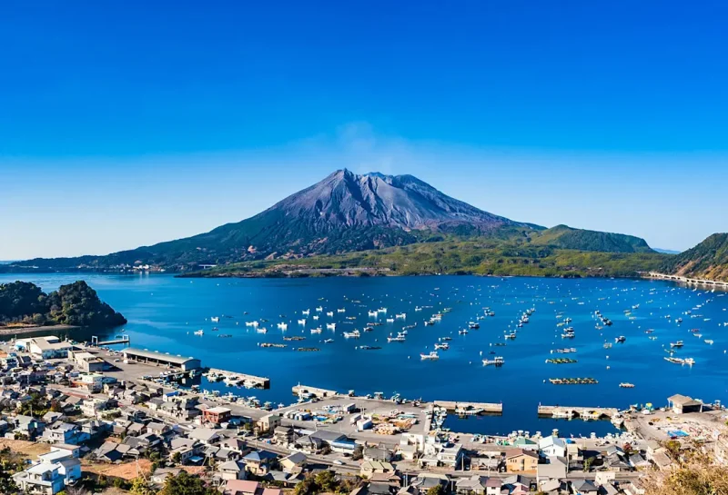 Volcanic mountain overlooking a harbor.