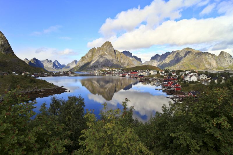 Scenic mountains reflecting in calm water.
