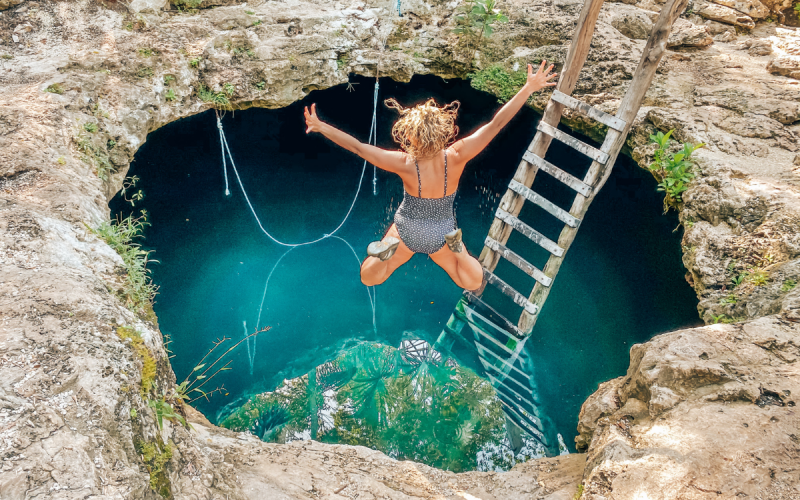 Person jumping into a cenote